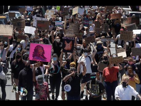 A crowd marches in San Francisco, California, yesterday during a protest calling for an end to racial injustice and accountability for police. 