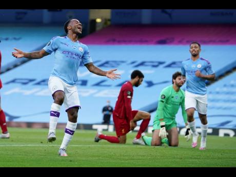 Manchester City’s Raheem Sterling celebrates after scoring his team’s second goal against Liverpool during their English Premier League match at Etihad Stadium in Manchester, England, Thursday, July 2, 2020. 
