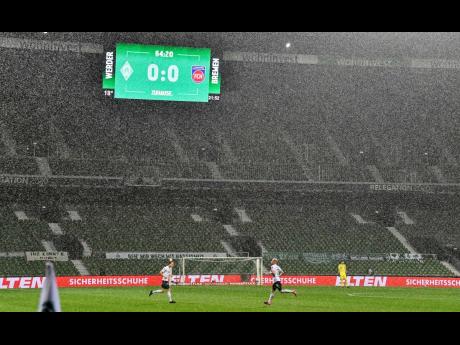 The board shows the result in heavy rain during the German Bundesliga relegation first-leg football match between Werder Bremen and 1. FC Heidenheim in Bremen, Germany, on Thursday, July 2.