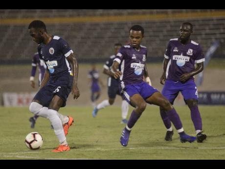 File Photos
Nickache Murray of Jamaica College (left) moves away from Kingston College defenders during their ISSA Champions Cup semi-final game at the National Stadium on Saturday, November 16, 2019.