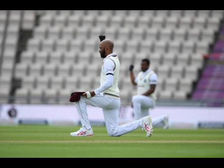 West Indies’ Roston Chase takes a knee on the first day of the first cricket Test match between England and West Indies at the Ageas Bowl in Southampton, England, yesterday.