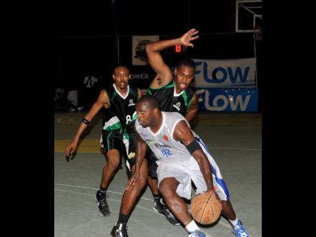 File
In this file photo from August 16, 2013, an Urban Knights player (front) is challenged by two Spanish Town Spartans opponents during game two of the FLOW National Basketball League finals at the National Stadium Court.