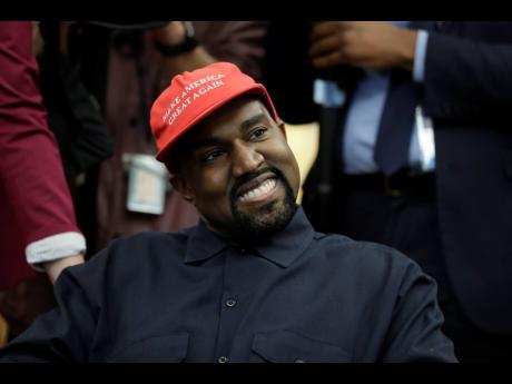 Rapper Kanye West wears a Make America Great Again hat during a meeting with President Donald Trump in the Oval Office of the White House in Washington in October 2018.  