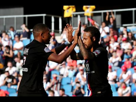 Paris Saint Germain’s Neymar (right) celebrates with teammate Kylian Mbappe after he scored a goal during a friendly  match between Paris Saint Germain and Le Havre, in Le Havre, western France, Sunday, July 12, 2020. 