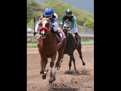 BALAZO (left), ridden by Paul Francis, on his way to victory ahead of BUCKALUCK (right), ridden by Christopher Mamdeen, in the second race at Caymanas Park on Sunday, July 5.  