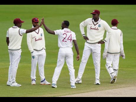 Credit: AP West Indies’ Kemar Roach (centre) celebrates with teammates after the dismissal of England’s Jos Buttler during the fourth day of the second Test match at Old Trafford in Manchester, England, on Sunday, July 19.
