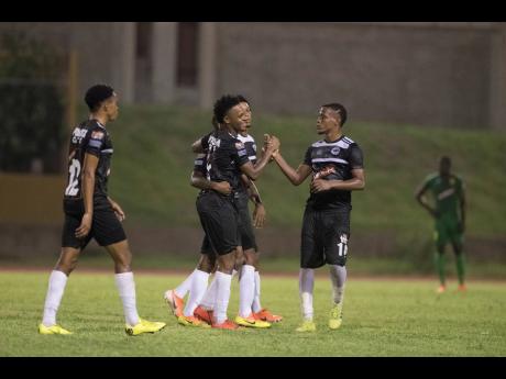 Cavalier’s Alex Marshall (second right) celebrates with teammates after scoring a penalty kick in a Red Stripe Premier League game against Humble Lion at Stadium East on Sunday, September 15, 2019.