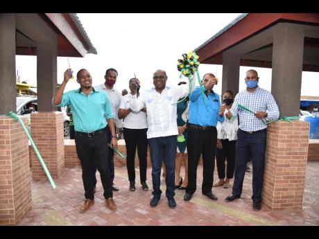 Minister of Tourism Edmund Bartlett  (second left, front row), flanked by (from left) MP for South St Elizabeth Floyd Green; Mayor of Black River Derrick Sangster; and Stephen Edwards, director of projects, Tourism Product Development Company Ltd.