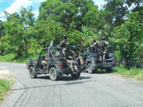 Members of the Jamaica Defence Force on a series of operations in Amity, St James, yesterday, following the fatal shooting of Delano ‘Prekeh Boy’ Wilmot. 