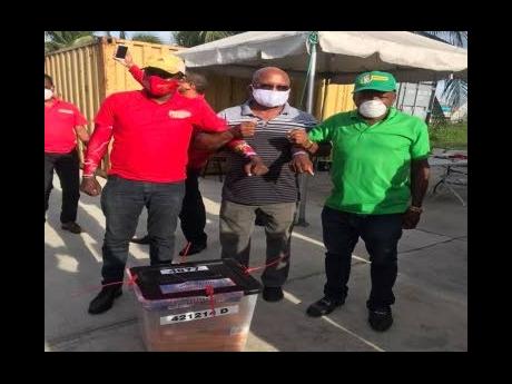 Agents of the two main political parties in Guyana’s elections.