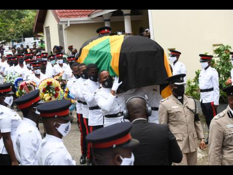 A bearer party carry the coffin with the remains of Decardo Hylton from the Bread of life Ministries in Linstead, St Catherine, on Saturday.