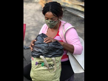 Aretha Bryan with all she has in her name, a plastic bag with clothes she received from her sister.