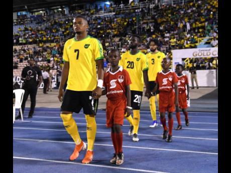 Leon Bailey leads the Reggae Boyz on to the field at the National Stadium for a first-round Gold Cup match against Honduras in 2019.