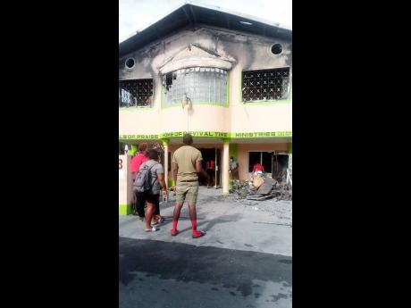 Onlookers view the burnt-out church.