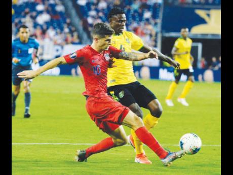 FILE
United States midfielder Christian Pulisic (10) kicks the ball past Jamaica midfielder Andre Lewis (4) during the second half of a CONCACAF Gold Cup semi-final match Wednesday, July 3, 2019.