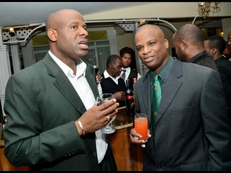 Nehemiah Perry (left) chats with Orville Brown at the Calabar Old Boys Annual Reunion Dinner at the Mona Visitors’ Lodge on Saturday, October 5, 2013.