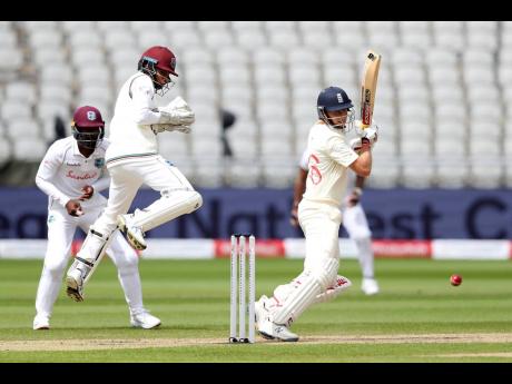 England’s captain Joe Root (right) plays a shot during the first day of the third cricket Test match between England and West Indies at Old Trafford in Manchester, England, Friday, July 24, 2020. 