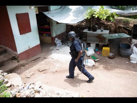 Credit: Gladstone Taylor Police secure the scene of Saturday’s shooting.