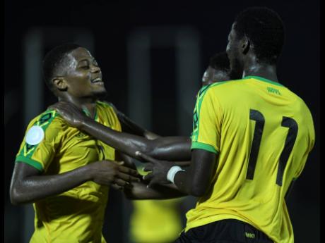 Reggae Boyz striker Leon Bailey (left) celebrates with  Devon Williams (partially hidden) and Shamar Nicholson during Jamaica’s Concacaf Nations League match against Antigua and Barbuda at the Montego Bay Sports Complex on Friday, September 6,2019.