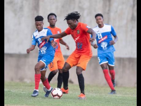Action from the Red Stripe Premier League between defending champions Portmore United and Tivoli Garden at the Spanish Town Prison Oval on Sunday, March 1.