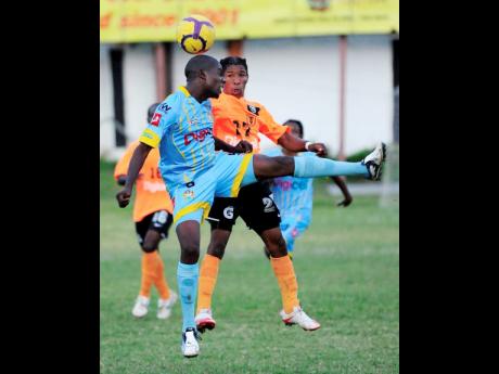 In this file photo from December 2010, Kenardo Forbes (left), then of Waterhouse FC, contests a header with Tivoli Gardens’ Shawn McKoy during their Premier League match at the Edward Seaga Sports Complex. 