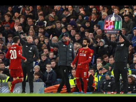 Liverpool’s manager Jurgen Klopp (centre) shouts out from the touchline as Liverpool’s Adam Lallana (left) is substituted by Liverpool’s Mohamed Salah during the English FA Cup fifth round match between Chelsea and Liverpool at Stamford Bridge stadium in London, Tuesday, March 3, 2020. 