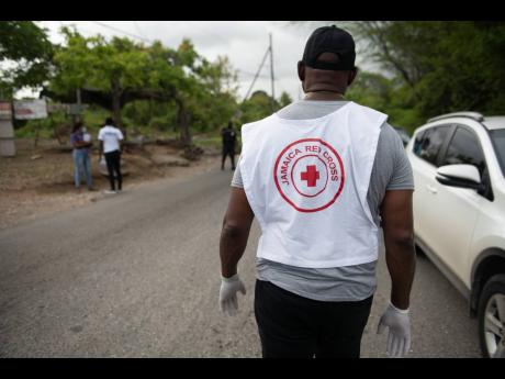 A member of the Jamaica Red Cross prepares to distribute supplies to residents.