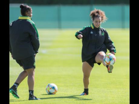 File
Dominique Bond-Flasza (left) looks on as Lauren Silver controls the ball during a training session as the Reggae Girlz prepare for the FIFA Women’s World Cup in France last year.