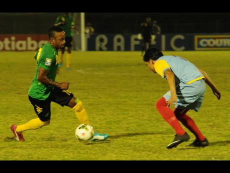 File
Jamaica’s Under-20 player Junior Flemmings (left) moves away from Aruba’s defender Jefferson Vegas in match at the Montego Bay Sports Complex in 2015.