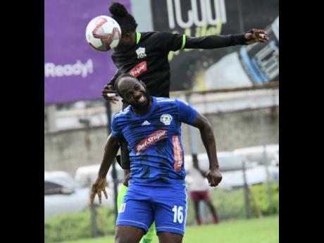 File
Mount Pleasant’s Francois Swaby (front) goes up for a header ahead of Molynes United’s Andrew Peddlar during  a Red Stripe Premier League encounter at the Waterhouse Mini Stadium in October last year.