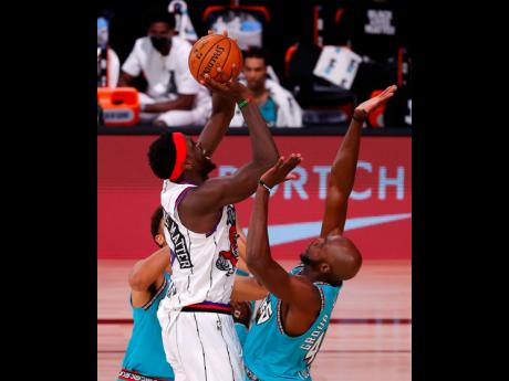 Toronto Raptors’ Pascal Siakam, front left, shoots over Memphis Grizzlies’ Anthony Tolliver, right, during the second quarter of an NBA basketball game Sunday, Aug. 9, 2020, in Lake Buena Vista, Florida.