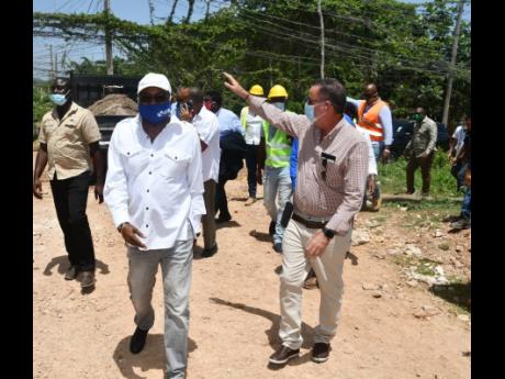Minister of Tourism  Edmund Bartlett (left); and Minister without Portfolio in the Ministry of Economic Growth and Job Creation, Daryl Vaz, tour a section of Grange Pen in St James, recently.
