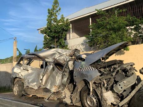 The wreckage of the Nissan motor car in which the family was travelling along the Rose Hall main road in St James.