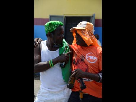 Despite supporting two different parties, Aggi (left) and his good friend, Abba, enjoy libations during Nomination Day.