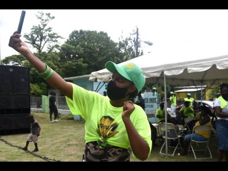 This JLP supporter takes a selfie as she joins others in cheering for Daryl Vaz, who is seeking a fourth term in West Portland.