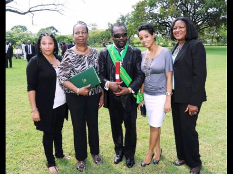 Frederick ‘Toots’ Hibbert (centre) received the Order of Jamaica in 2012. Here he shares the moment with members of his inner circle (from left) public relations agent Andrea Davis; his wife Doreen Hibbert; granddaughter Cressida Rattigan; and family friend Pamela Watson. 