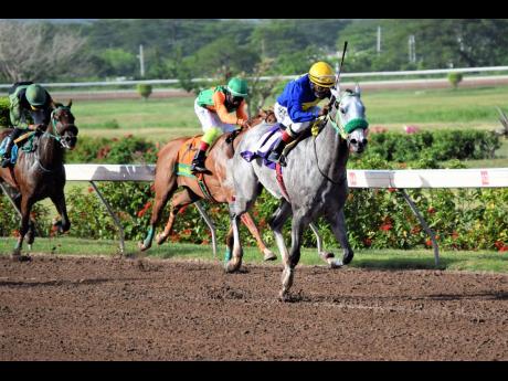 ENUFFISENUFF (right), ridden by Dane Nelson, on the way to winning the eighth race at Caymanas Park on Sunday, July 26.