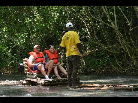 Rafting on the Martha Brae River.  Raft captains are among the category of workers who will benefit from the tourism pension scheme.