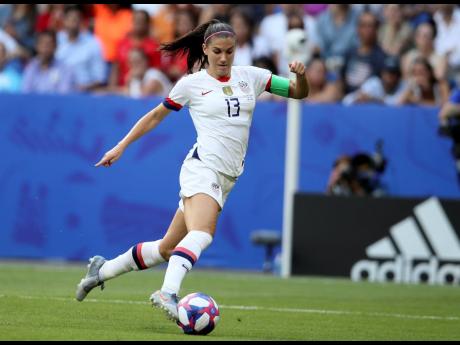 In this July 7, 2019, file photo, United States’ Alex Morgan controls the ball during the Women’s World Cup final soccer match against The Netherlands at the Stade de Lyon in Decines, outside Lyon, France. 