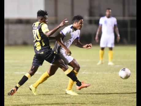 Credit: File Waterhouse’s Stephen Williams dribbles away from Elliader Dorius of Don Bosco from Haiti in their Concacaf club match at the Anthony Spaulding Sports Complex on February 2.