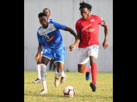 File
Dunbeholden’s Shaquille Dyer pulls away from Portmore United’s Shai Smith in a Red Stripe Premier League mathc on December 1, 2019.