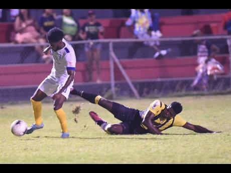 Waterhouse’s Kenroy Howell slips away from Jerome Odilon of Don Bosco in a Concacaf club football match earlier this year.