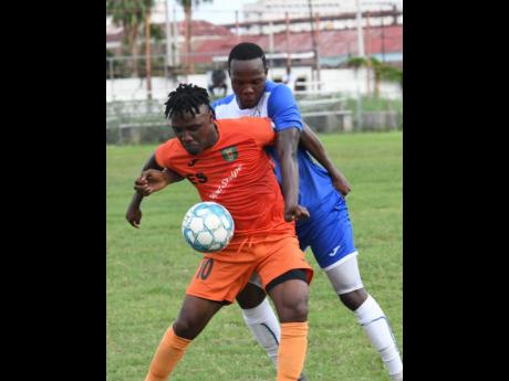 FILE
Tivoli Gardens’ Jermaine Johnson shields the ball from Portmore United’s Ryan Wellington during a Premier League match on October 6, 2019.