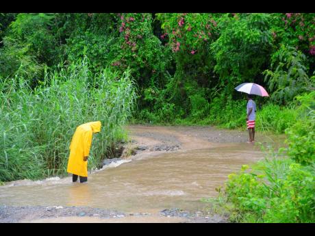 Credit: Nicholas Nunes Residents in Llandewey, St. Thomas, have resorted to using a road, that goes through private property. However, they have to go across a dry river, which is flooded whenever it rains.