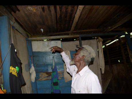 Credit: Nicholas Nunes James Smith in his Kent Village, St Catherine house, which is in need of repairs.