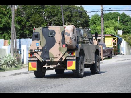 A JDF tank patrols the streets of Kingston.