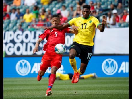Jamaica’s Damion Lowe (right) and Panama’s Gabriel Torres battle for the ball during the first half of a Concacaf Gold Cup match in Philadelphia last year.  