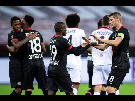 Leverkusen’s Leon Bailey, Wendel, goalscorer Moussa Diaby and Lars Bender (from left) cheer after the goal for the 3:1 during the Europa League Group C match between Bayer Leverkusen and OGC Nice in Leverkusen, Germany, yesterday.
