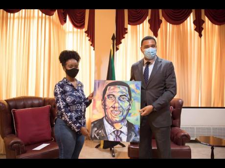 Shana-Gail Young presents Prime Minister Andrew Holness with one of her art pieces, Andrew Holness: Man of the People. The prime minister has contributed $250,000 to Young, who is seeking to complete a bachelor’s degree in civil engineering, which she started in 2014.