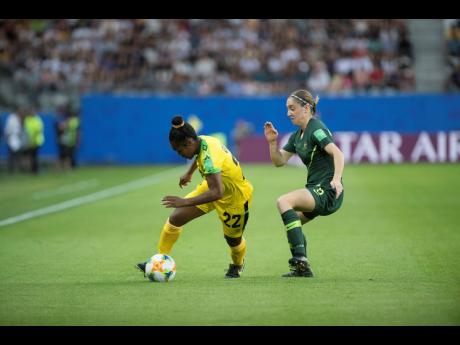 Reggae Girl Mireya Grey (left) turns neatly away from Australia’s Karly Roestbakken during their group-stage match in the 2019 FIFA Women’s World Cup in France.
